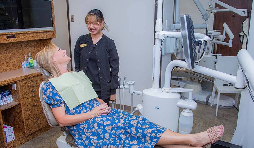 woman receiving dental care at Houston dental office Mills Dental Group